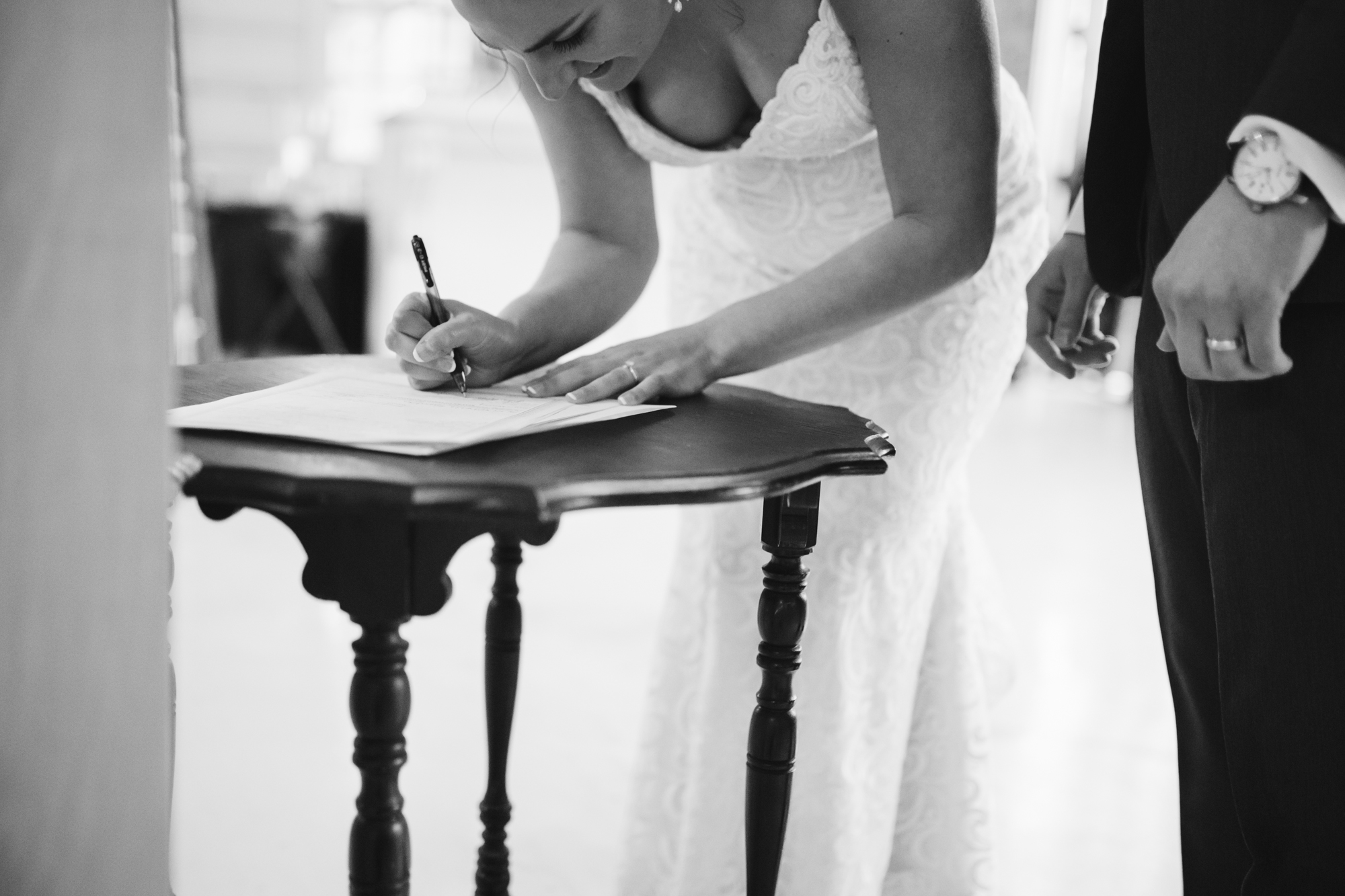 Signing the marriage license at a stone house of st charles wedding in missouri