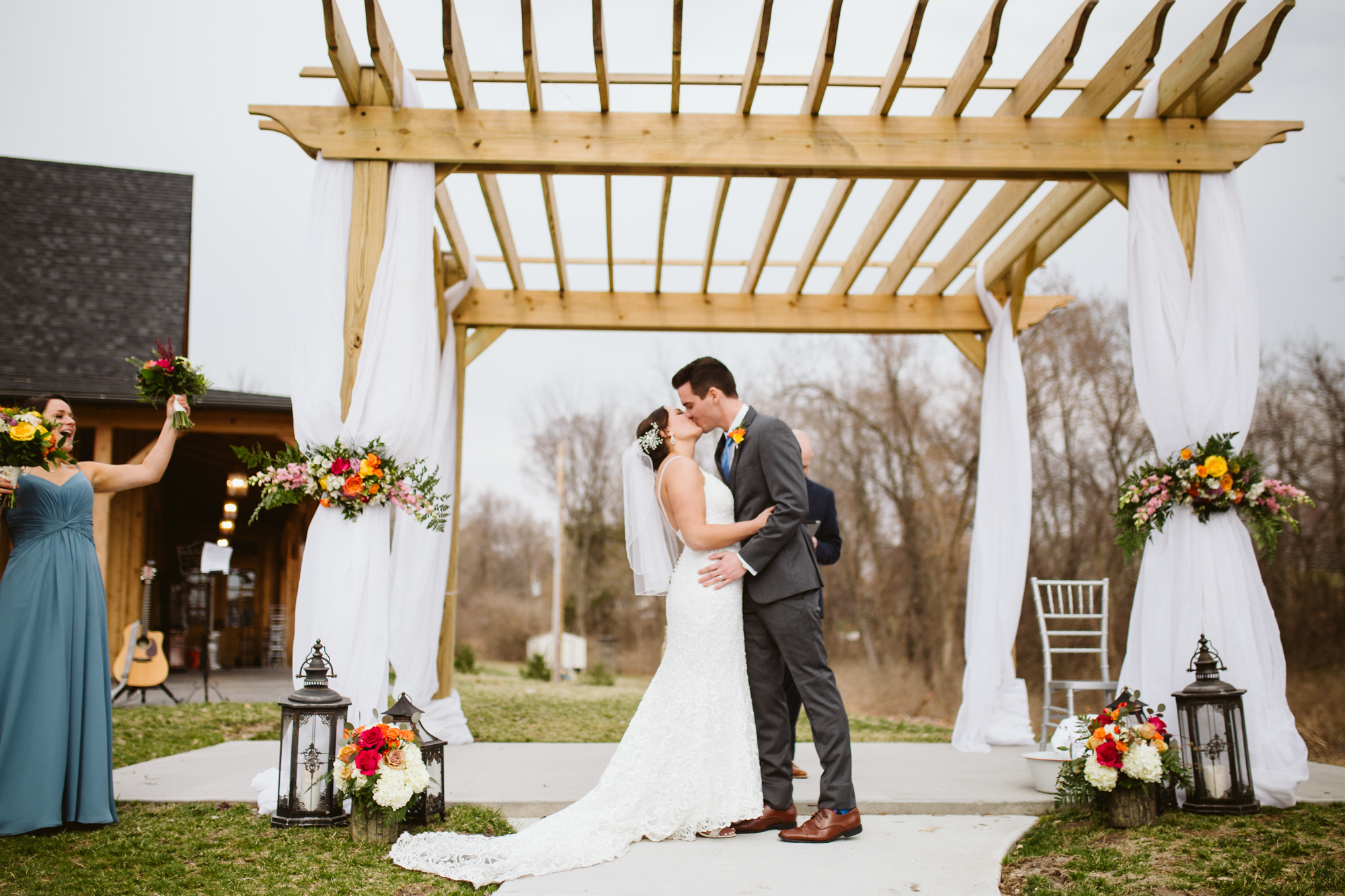 Bride and groom's first kiss at the stone house of st charles wedding venue in st louis