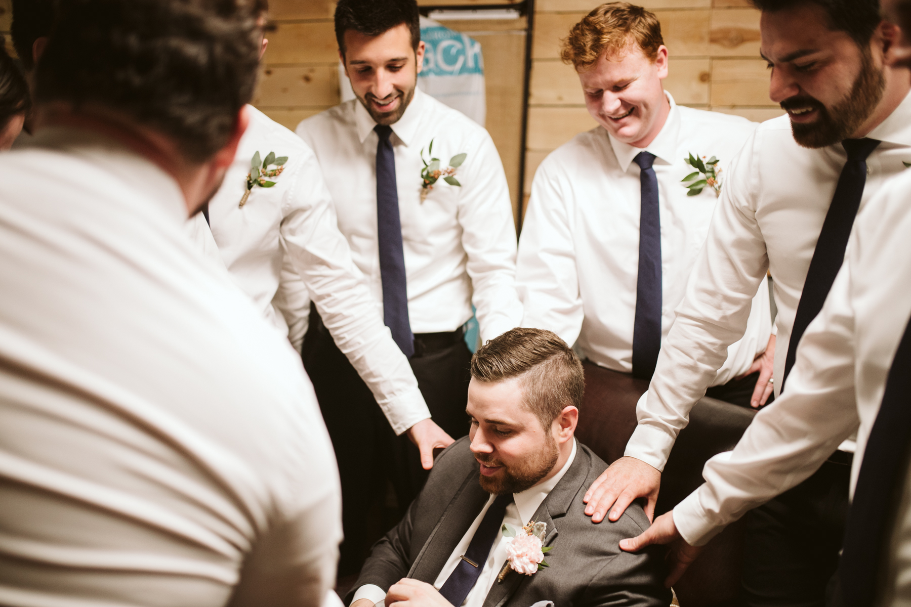 Groomsmen praying over the groom before A Rustic Wedding at Barn in the Bend in Nashville, Tennessee