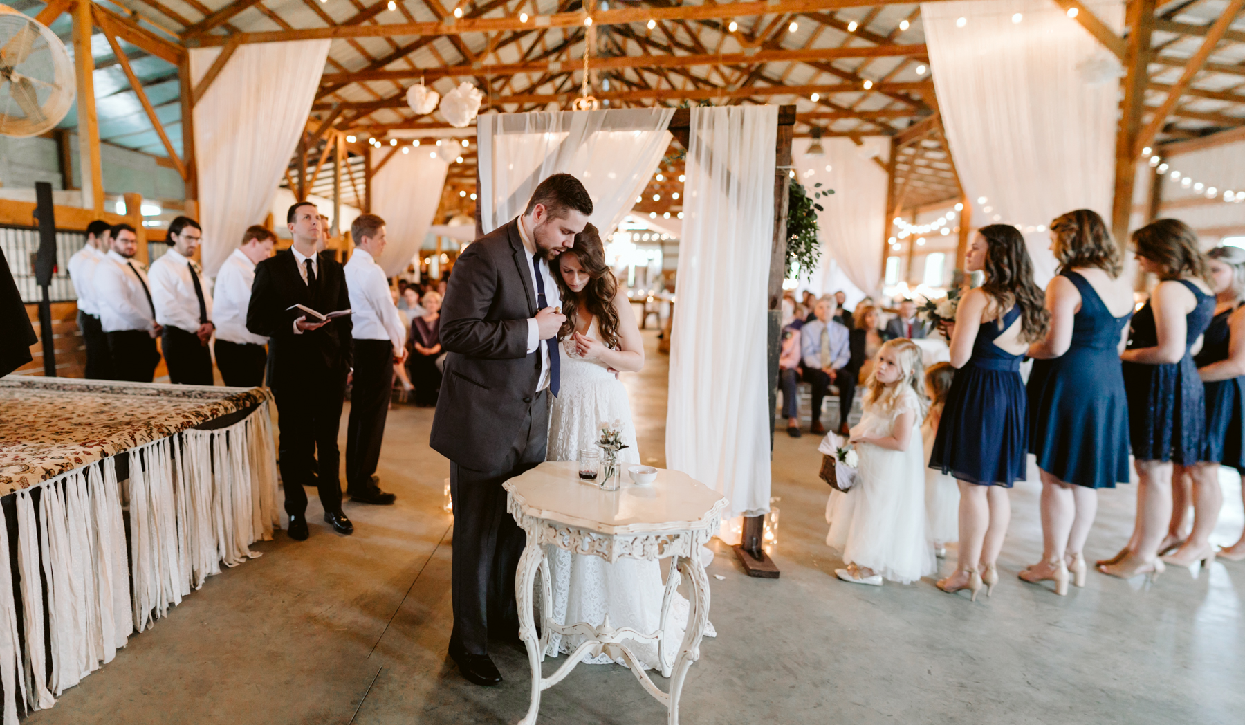 Bride and groom take communion during their ceremony at A Rustic Wedding at Barn in the Bend in Nashville, Tennessee