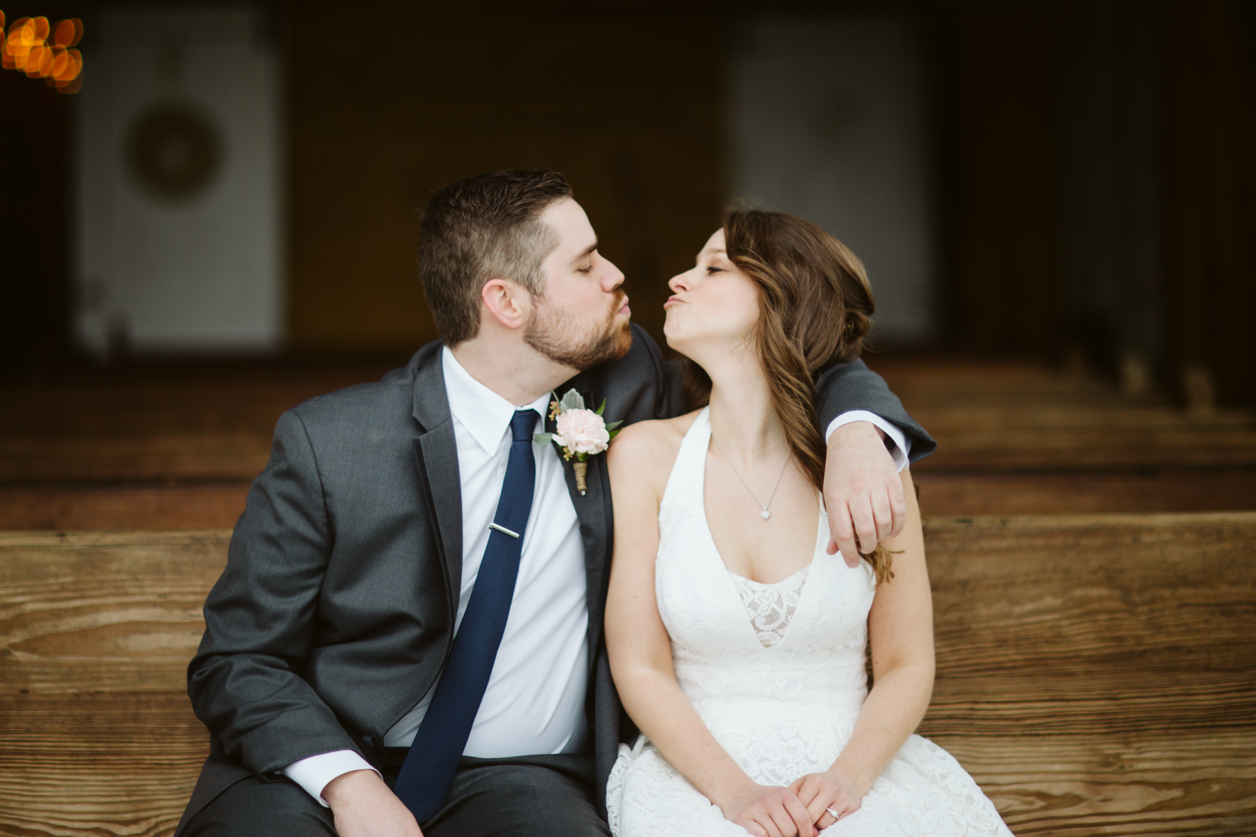 Bride and groom portraits on a pew at a A Rustic Wedding at Barn in the Bend in Nashville, Tennessee