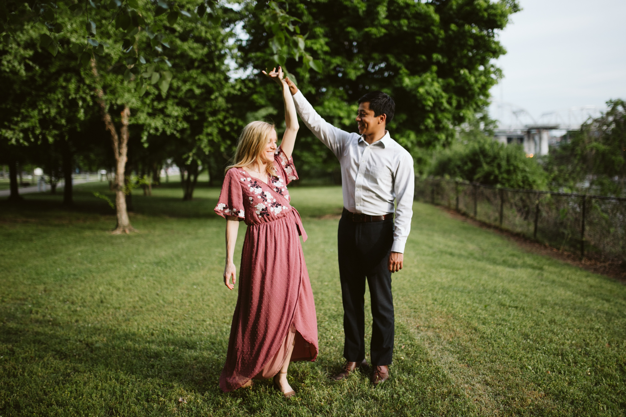 Spinning during a Summer Engagement Session on the Cumberland River in downtown Nashville, Tennessee