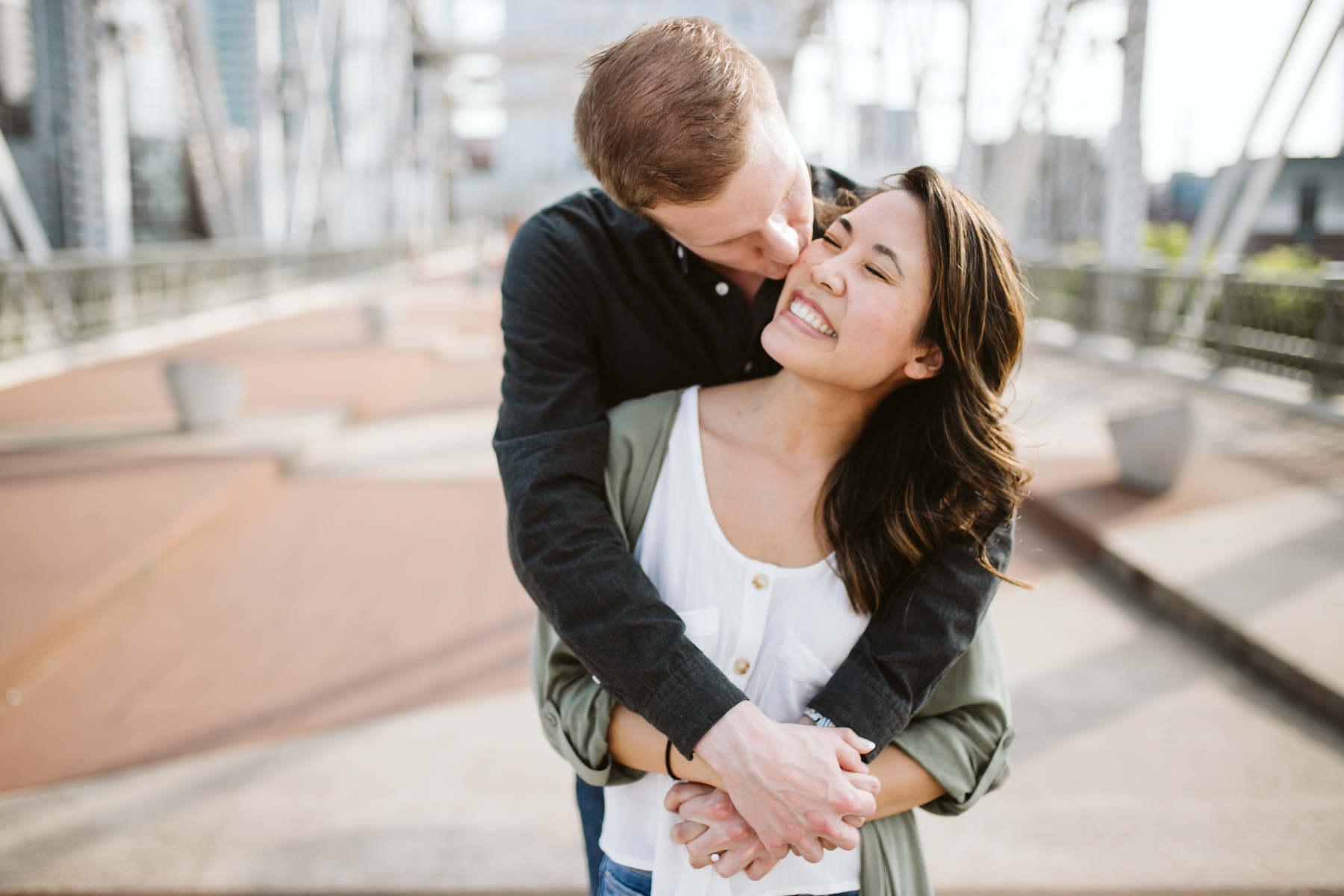 Sunny engagement session on the pedestrian bridge in downtown Nashville, Tennessee