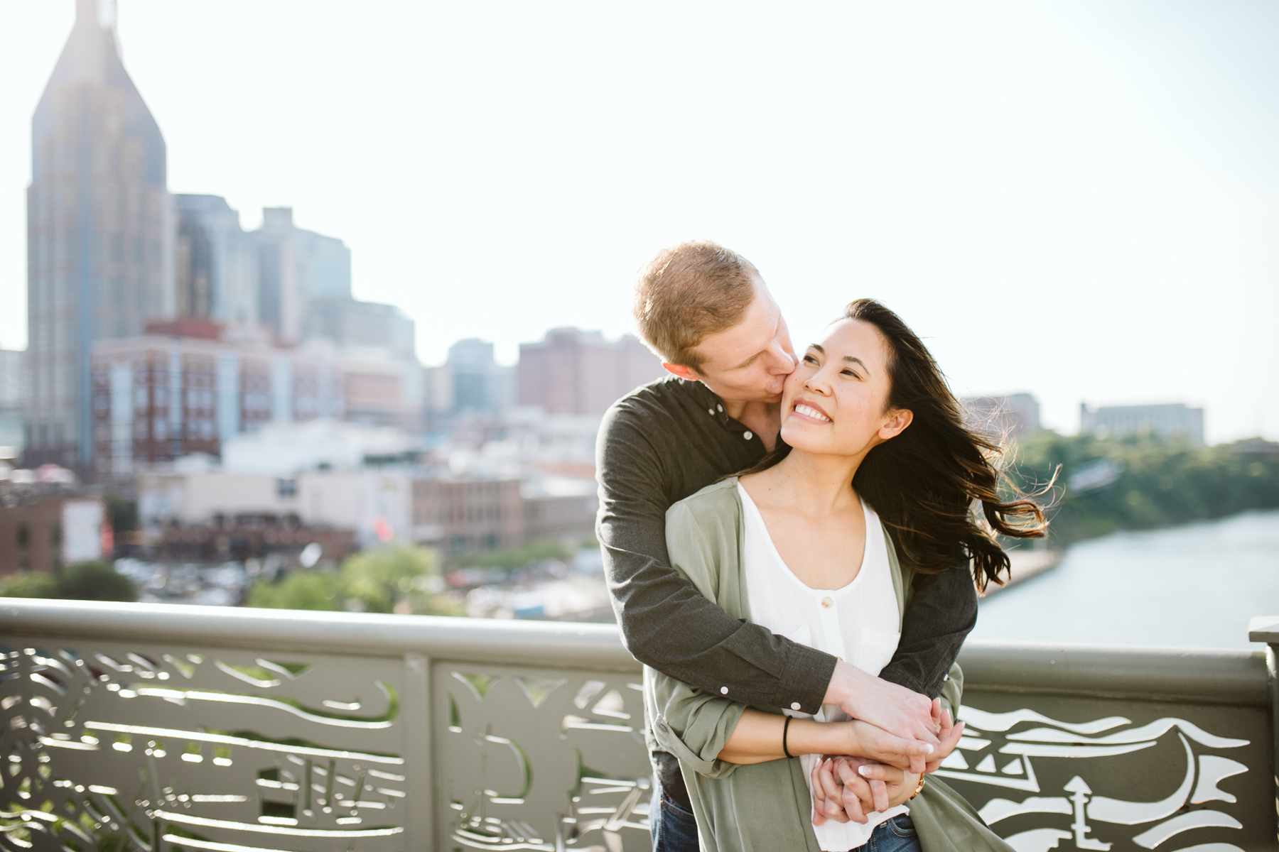 Sunny engagement session on the pedestrian bridge in downtown Nashville, Tennessee