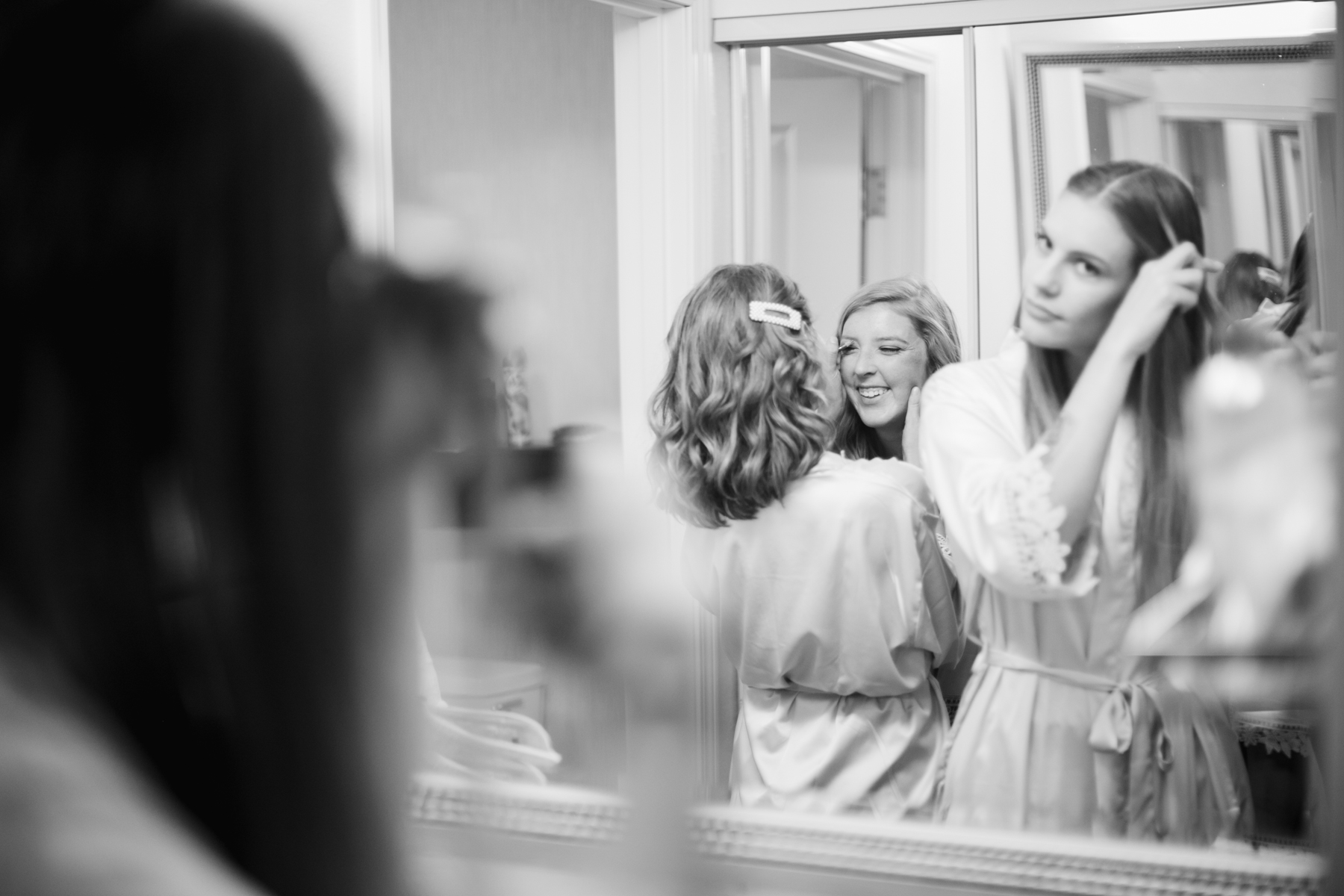 girls getting ready before a rainy summer wedding at brentwood hills church in Nashville, tennessee