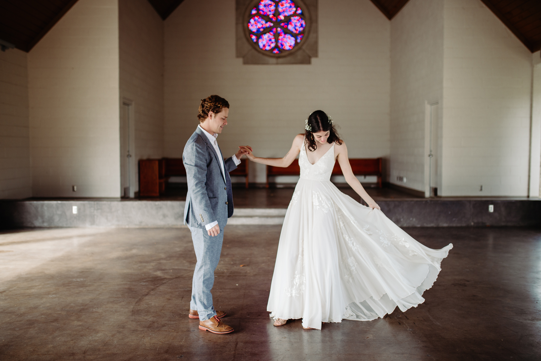 Bride spins her dress inside Lakeshore chapel before her downtown knoxville wedding at redeemer church