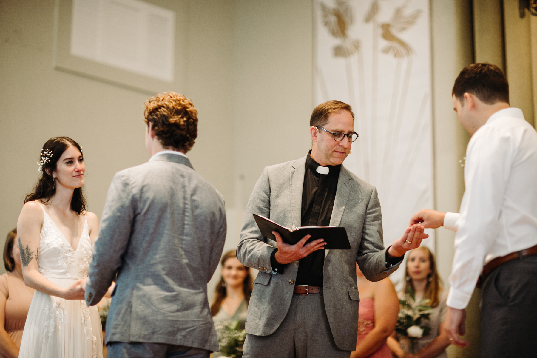 Pastor giving the rings during a downtown knoxville wedding at redeemer church