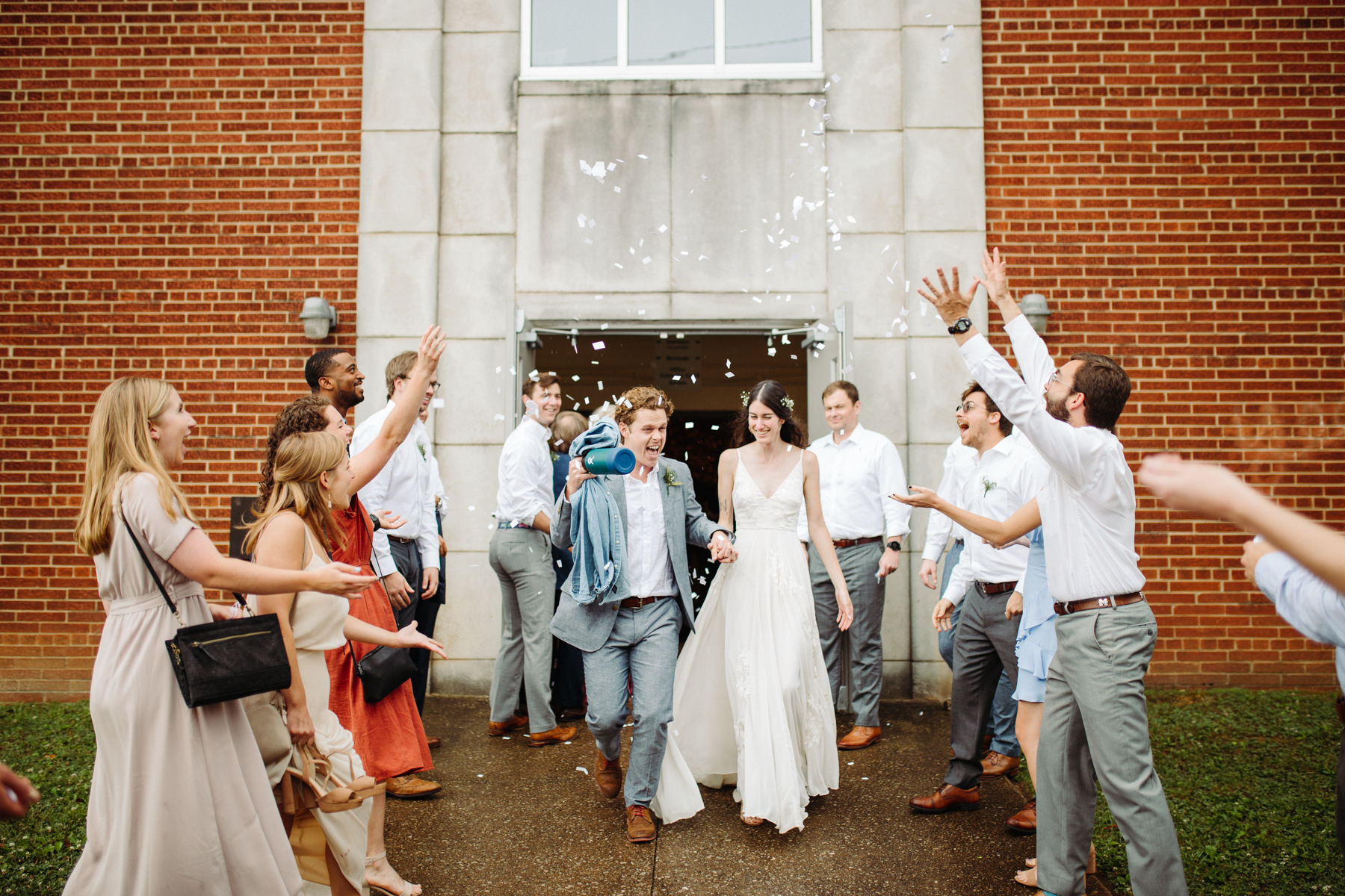 Paper confetti exit after a downtown knoxville wedding at redeemer church