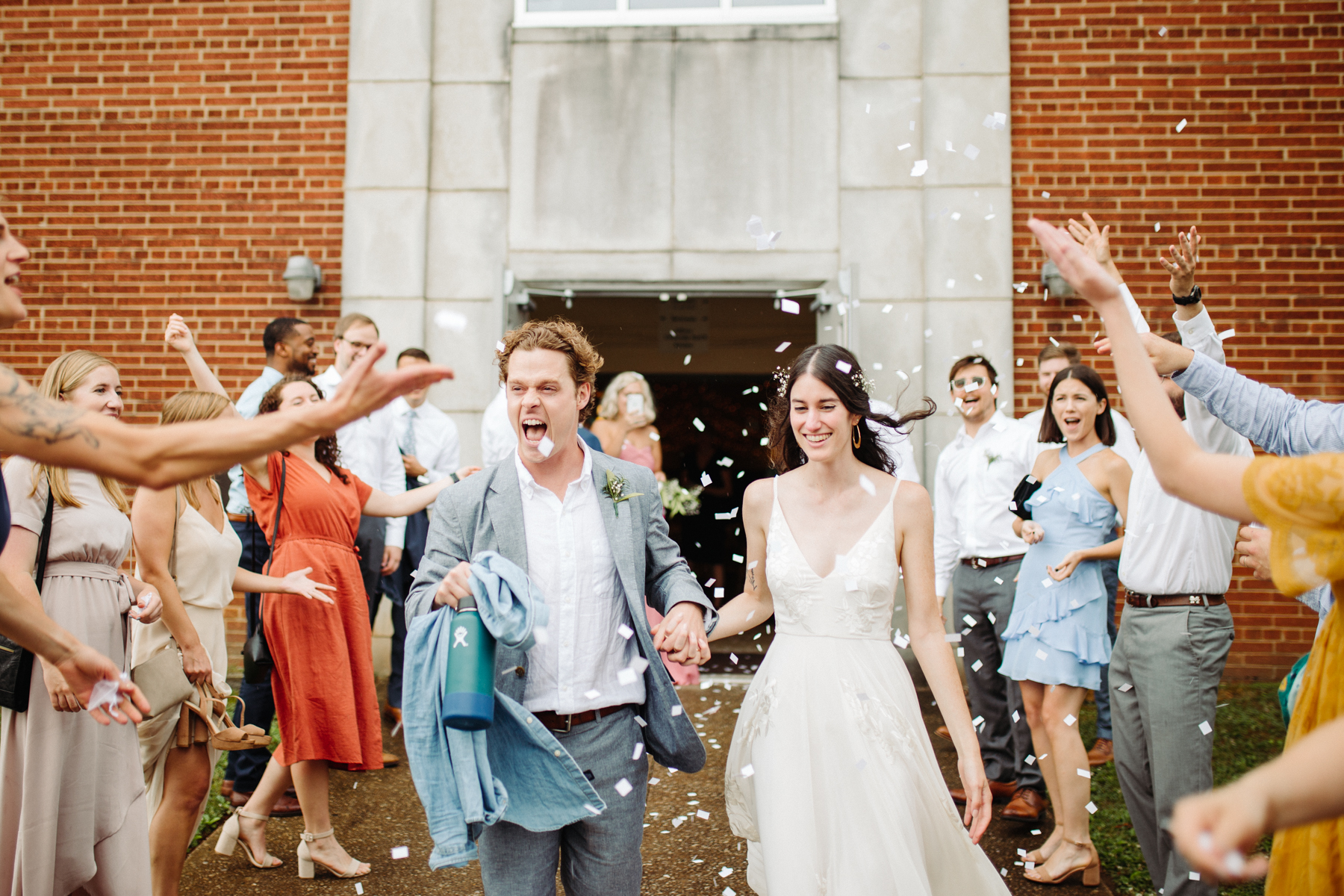 Paper confetti exit after a downtown knoxville wedding at redeemer church