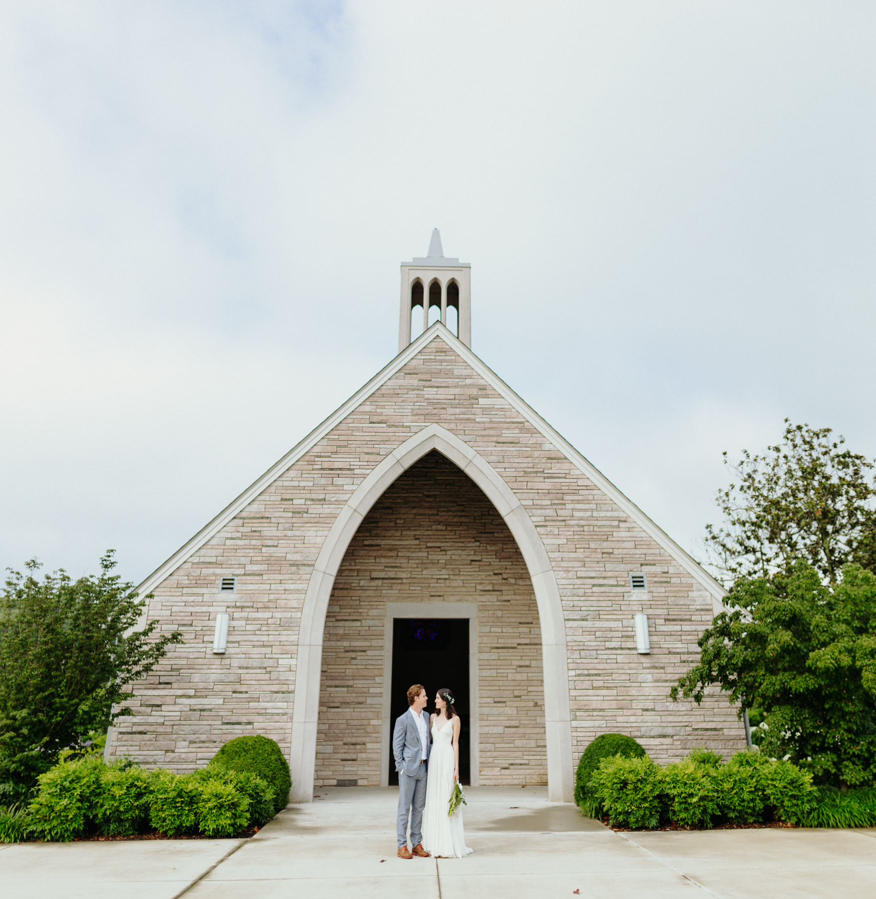 bride and groom in front of Lakeshore Chapel before a downtown knoxville wedding at redeemer church