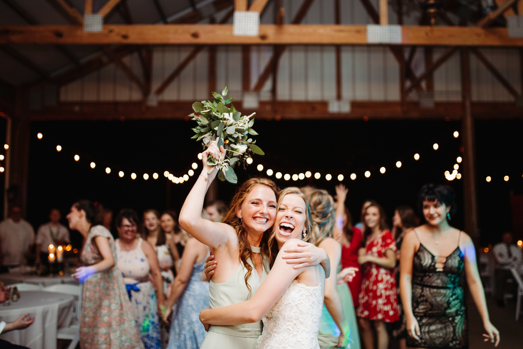 Winner of the bouquet toss at a stables at strawberry creek wedding in knoxville, tennessee