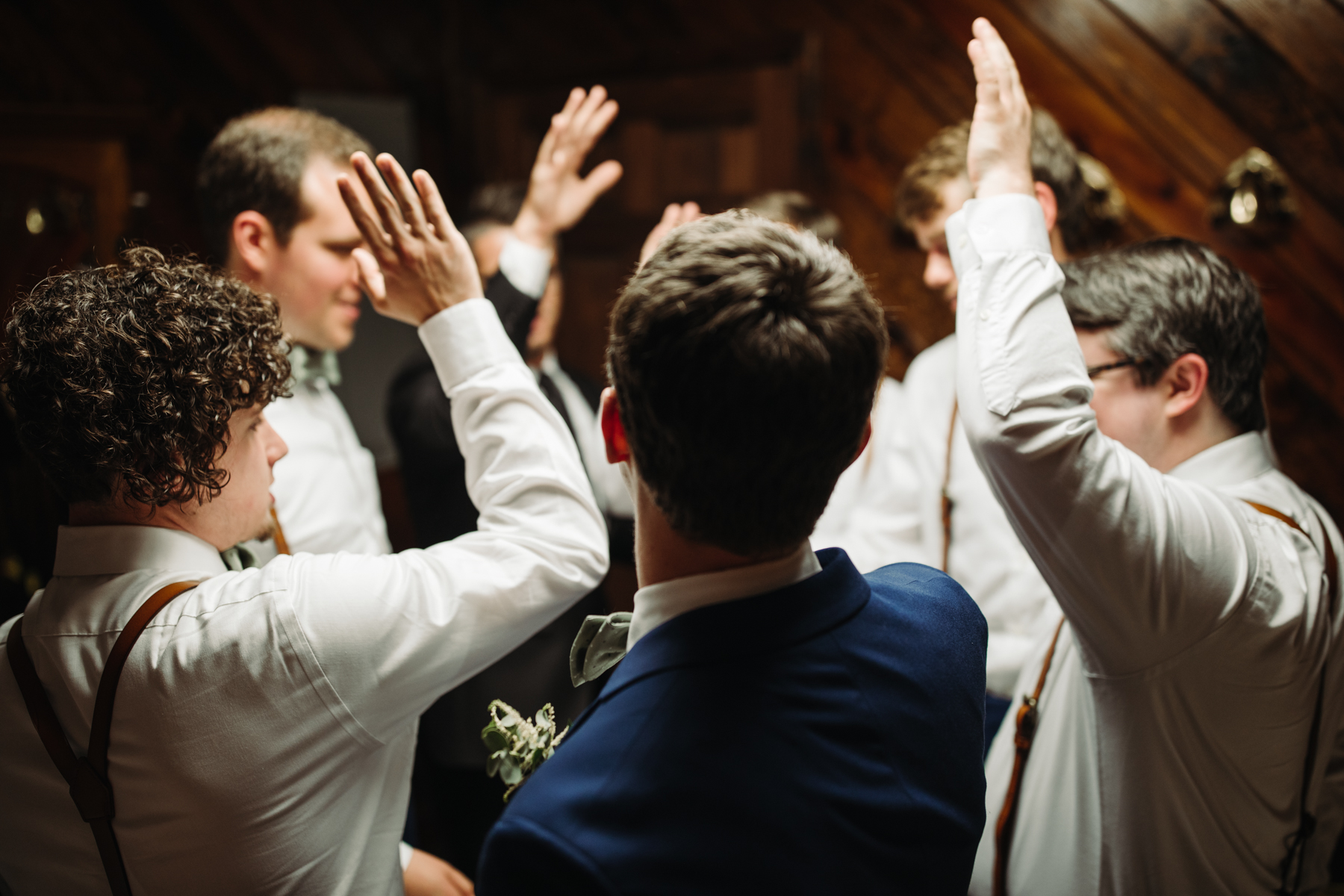 Groomsmen pray and give a cheer before a stables at strawberry creek wedding in Knoxville, tennessee
