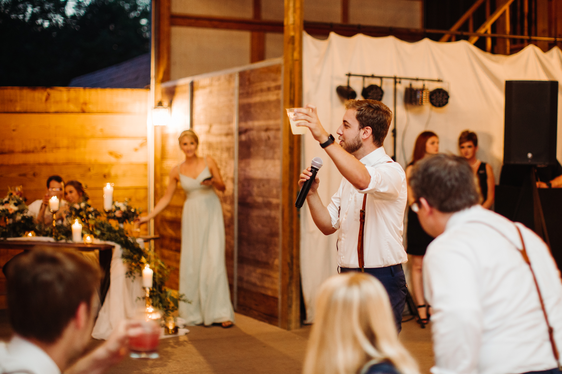 Best man gives a toast at stables at strawberry creek wedding in knoxville, tennessee