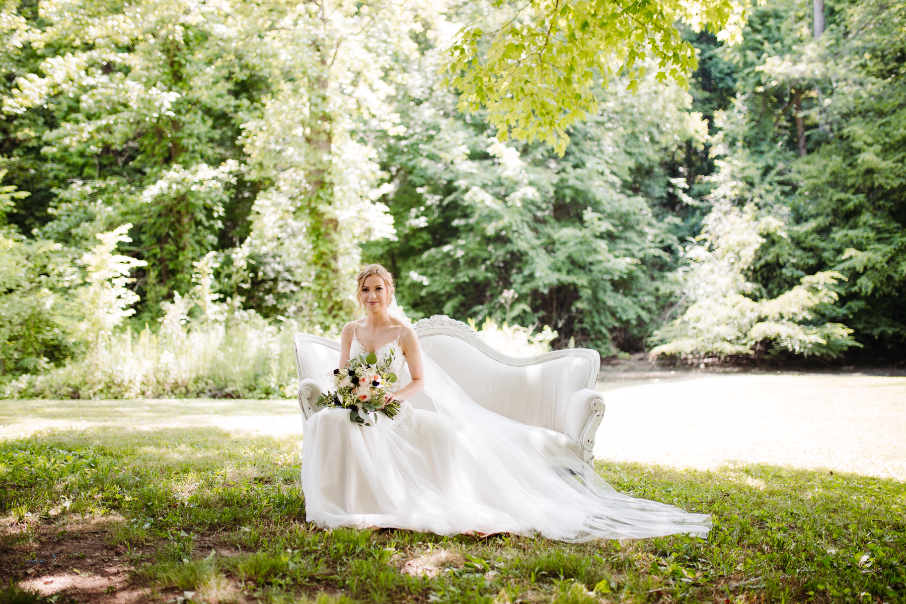 bridal portraits on a gorgeous white couch at a stables at strawberry creek wedding in Knoxville, tennessee