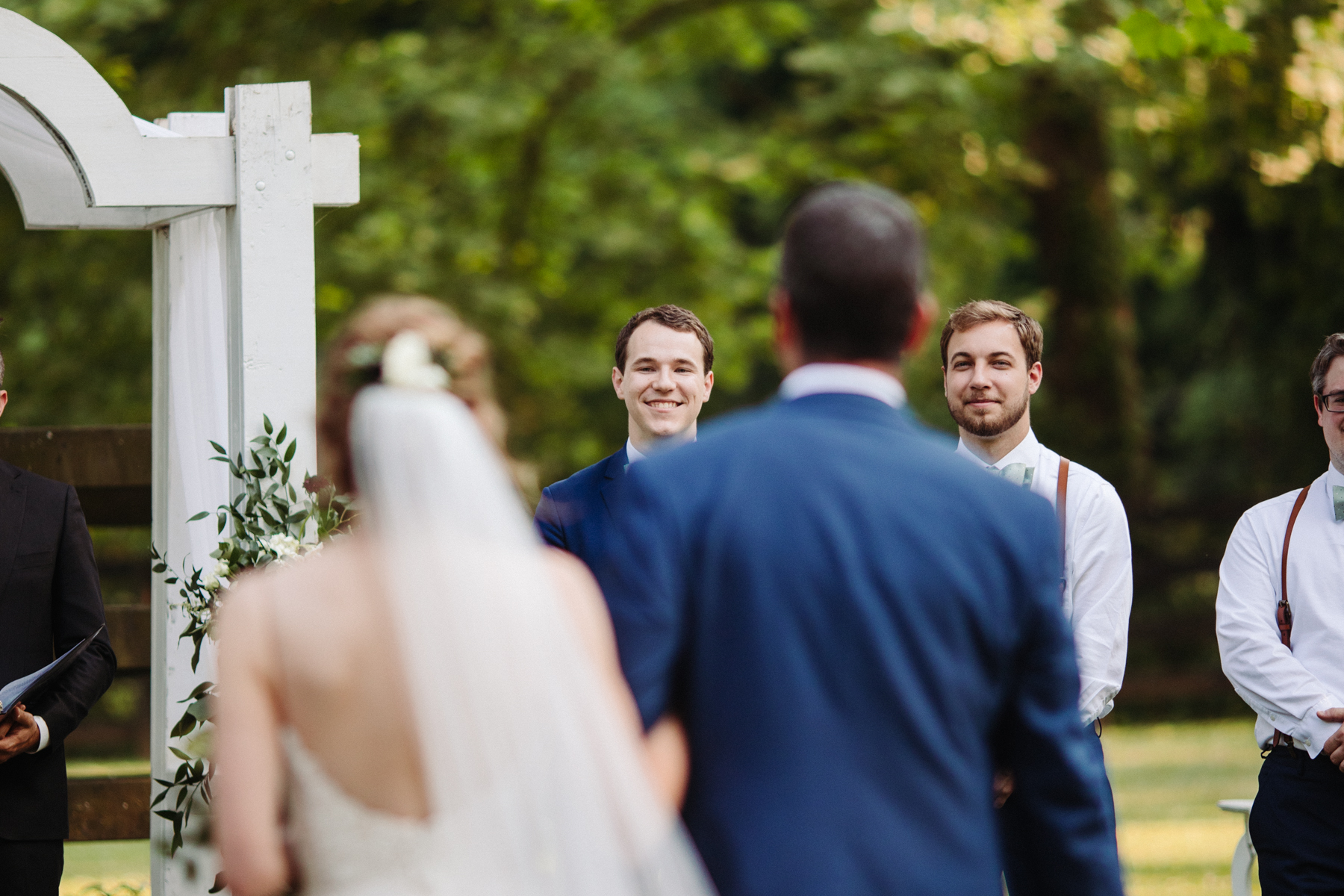 Groom watching his bride come down the aisle at a stables at strawberry creek wedding in knoxville, tennessee