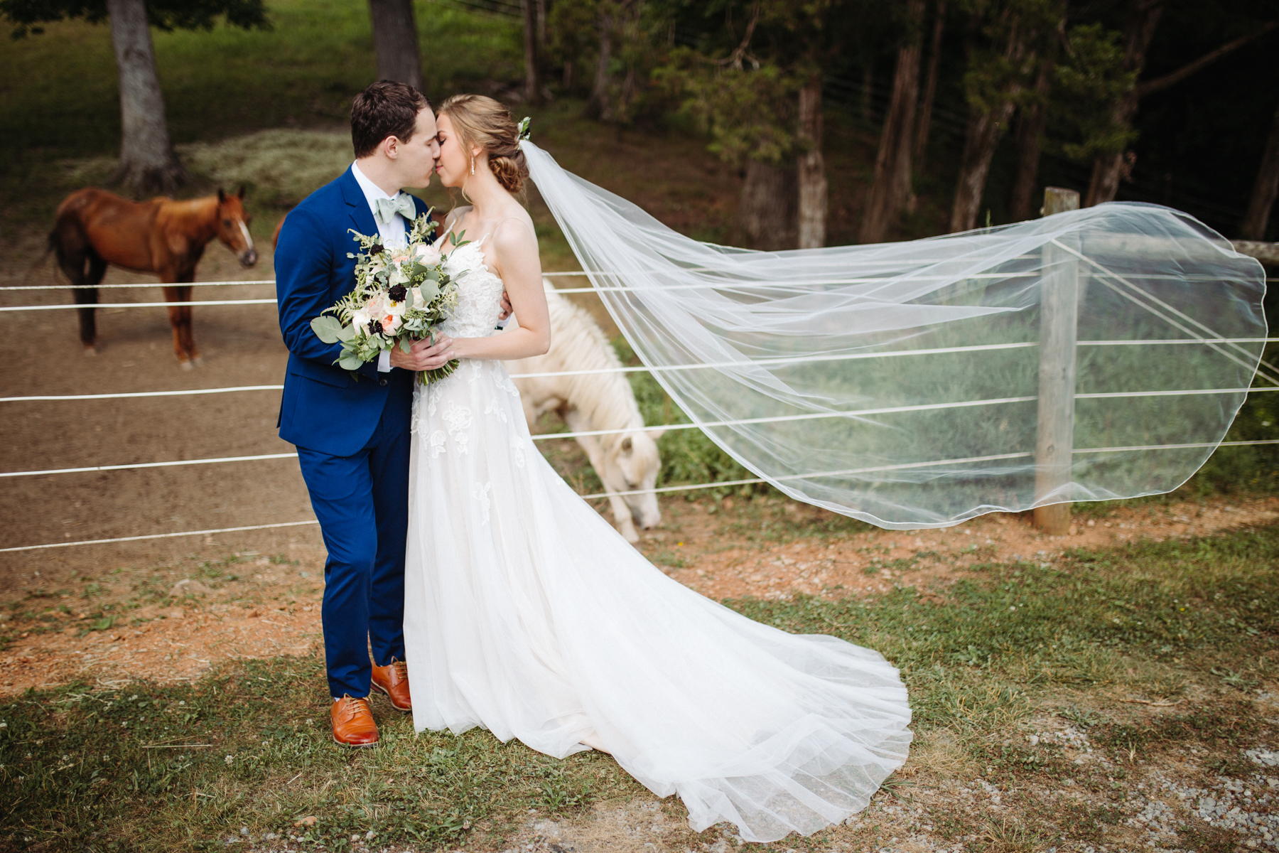 Bride and groom portraits beside the stables at a stables at strawberry creek wedding in Knoxville, tennessee, veil in the wind