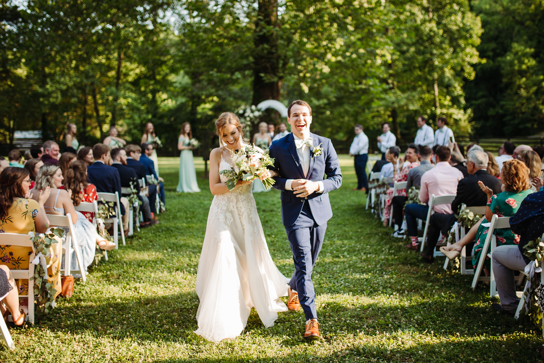 Bride and groom celebrate walking down the aisle at a stables at strawberry creek wedding in knoxville, tennessee