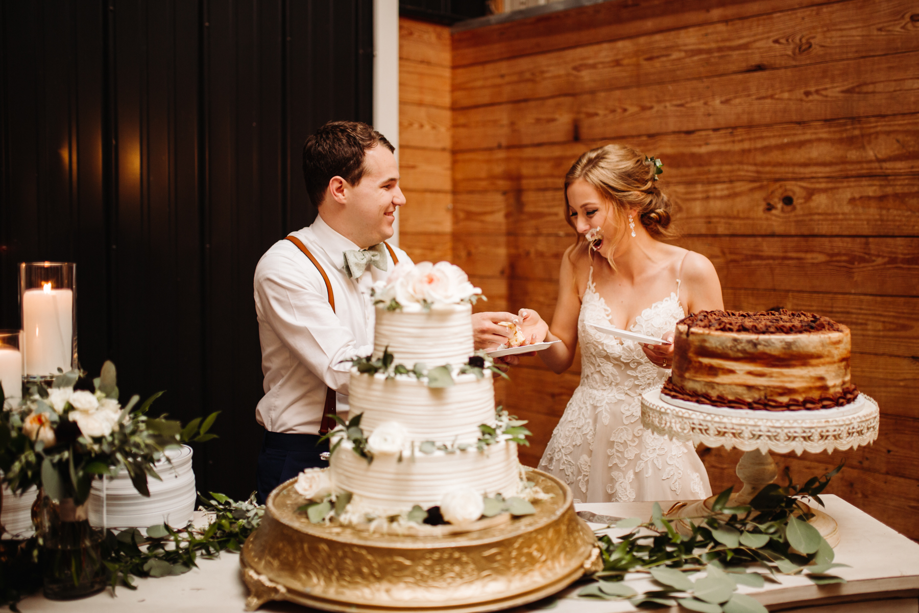 Bride and groom cut the cake at a stables at strawberry creek wedding in knoxville, tennessee
