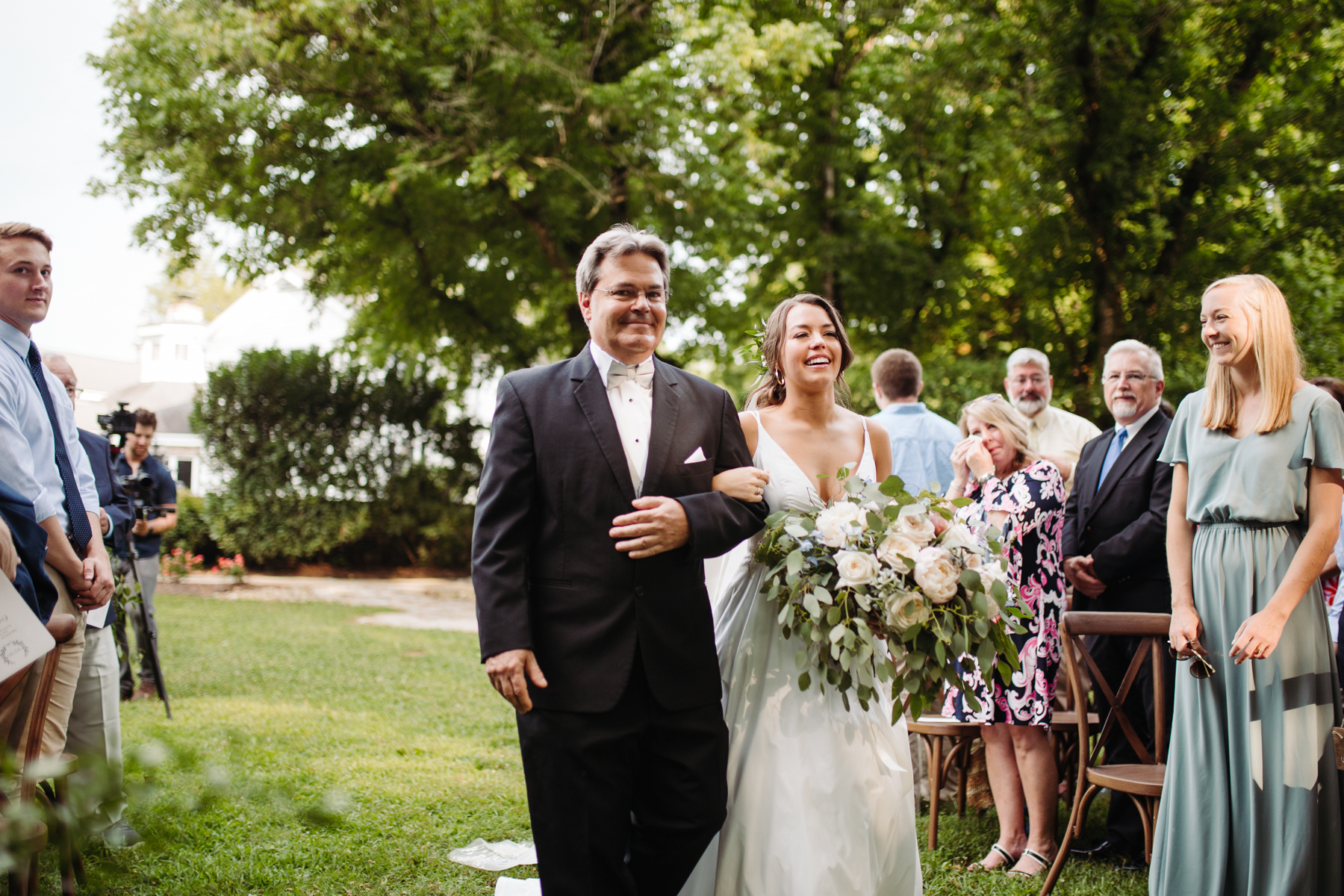 Father and bride walking down the aisle at a Sunny summer wedding at Dara's Garden in Knoxville, Tennessee 