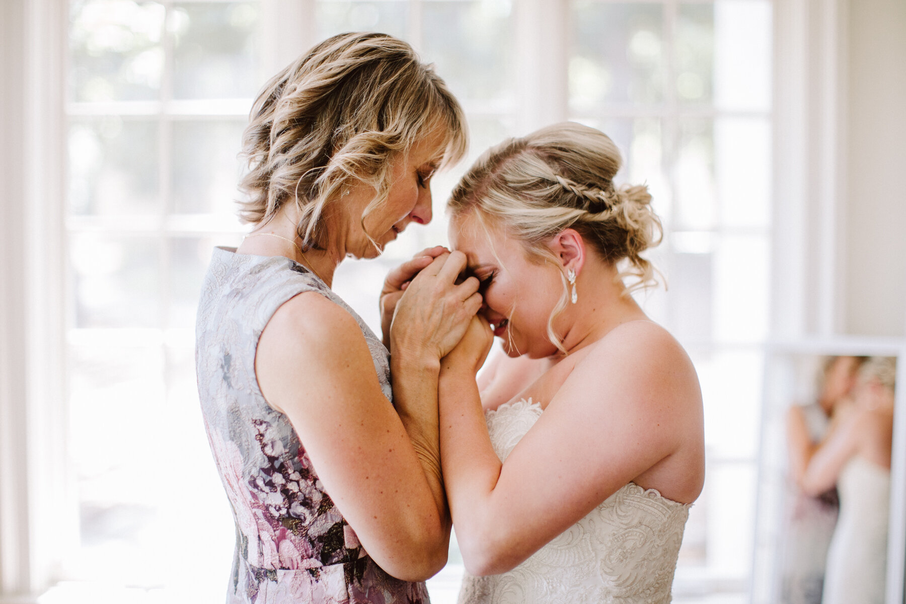 bride and her mother just after getting dressed before a sunny outdoor wedding at hunter valley farms in knoxville tennessee
