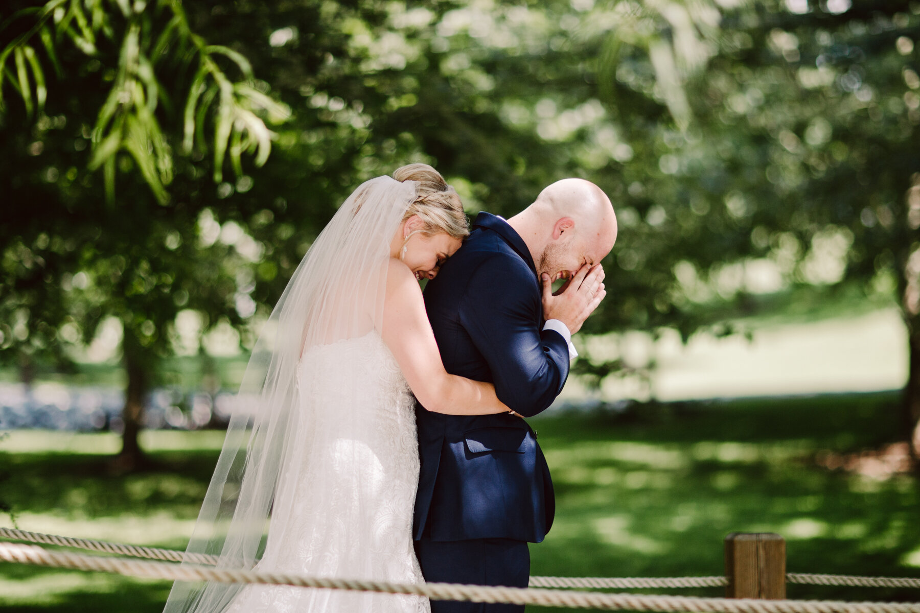 bride and groom's emotional first look before a sunny outdoor wedding at hunter valley farms in knoxville tennessee