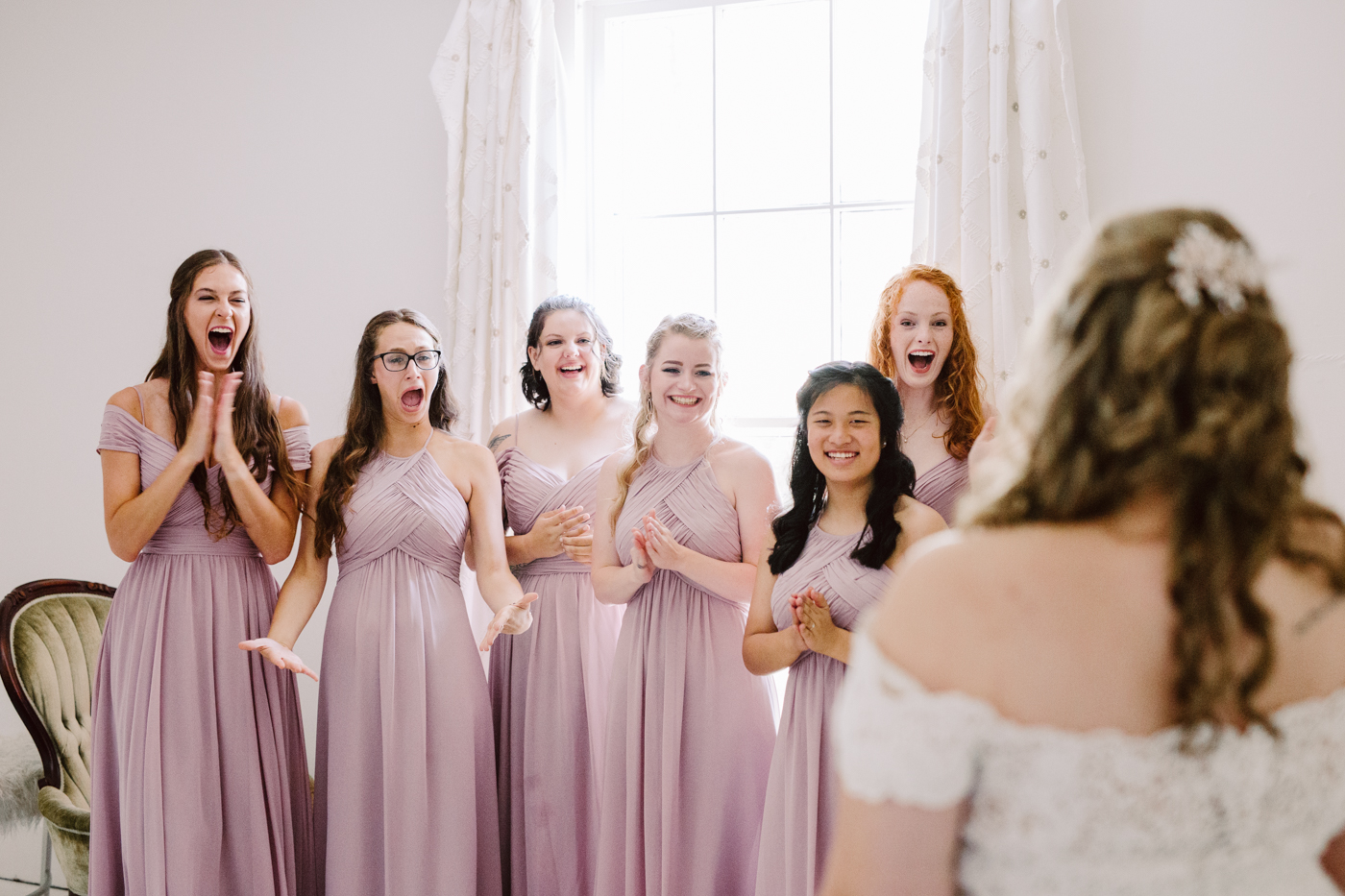 bridesmaids reveal before a sunny summer wedding at the venue at twin oaks in tennessee