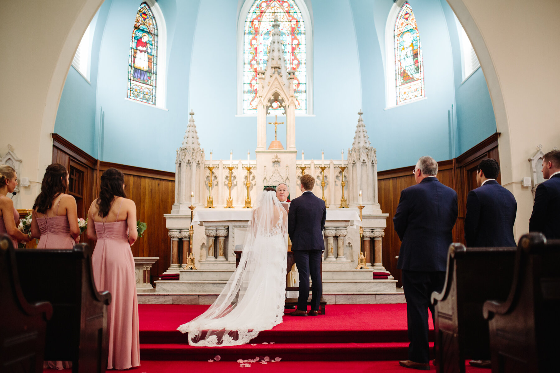 bride and groom at the altar in a Catholic Church at an elegant indoor summer wedding in Tennessee