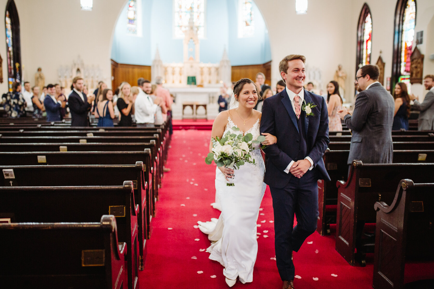 bride and groom walking down the aisle together at an elegant indoor summer wedding in Tennessee