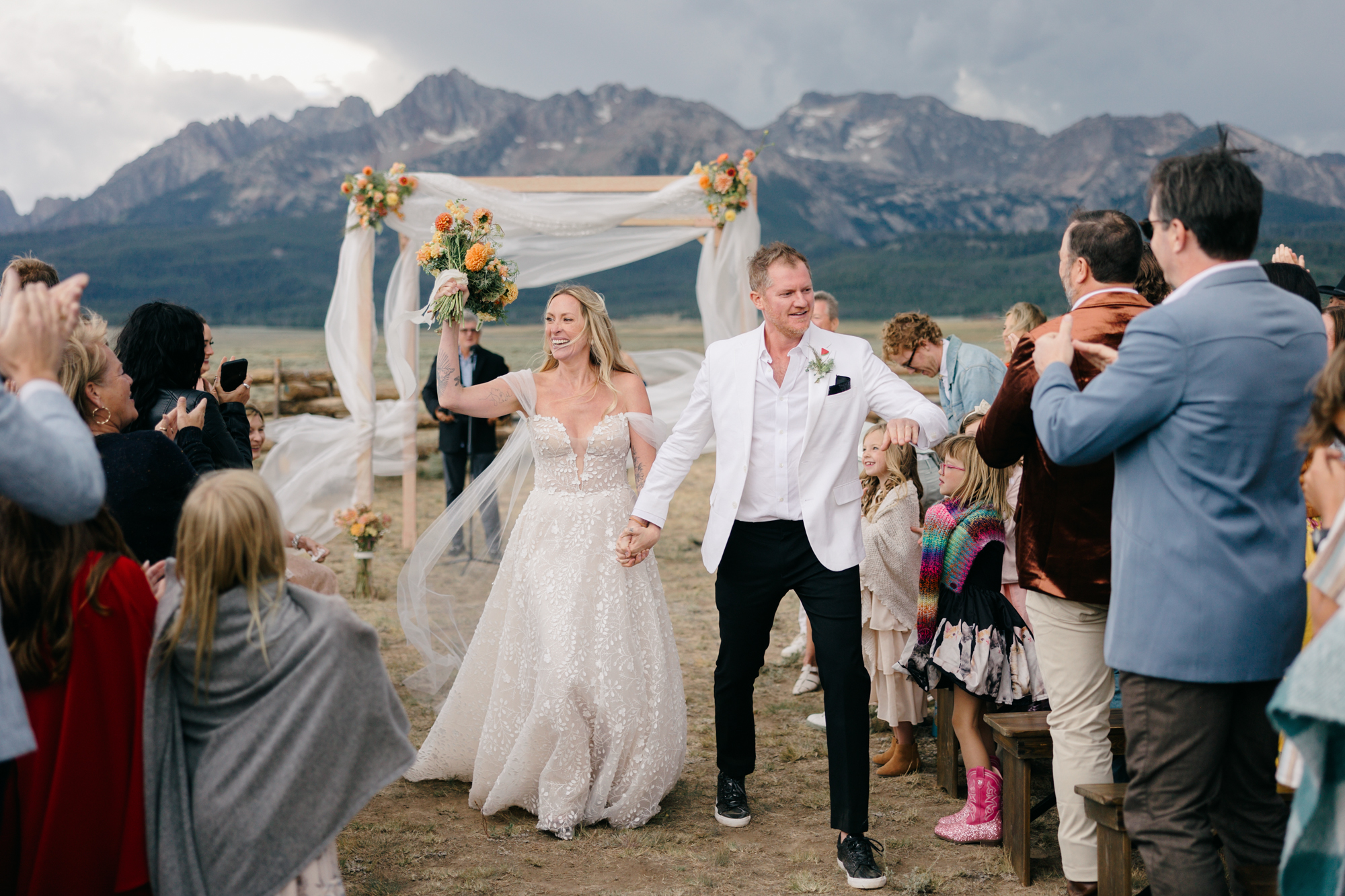 Denver Wedding Photographer - Bride and Groom leaving their mountain ceremony